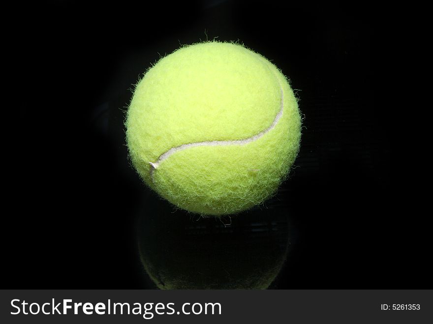 A tennis ball on black. A tennis ball on black