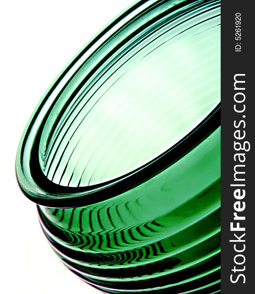 Abstract image of a green vase or bowl on a white background. The vase or bowl is textured.