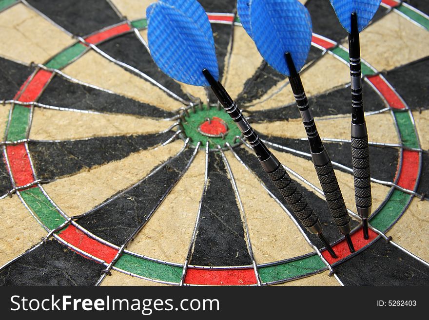 Three darts entire hit dartboard.