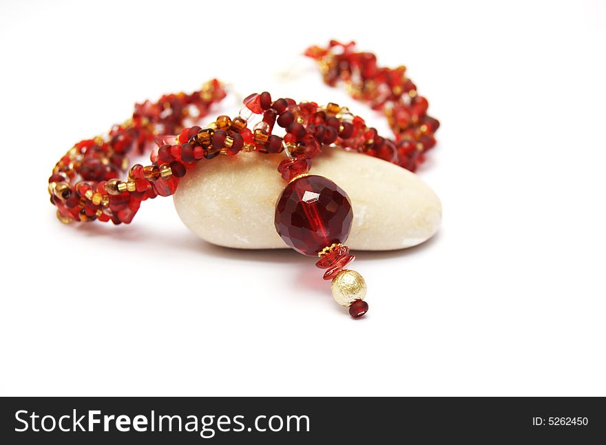 Red necklace on a white background.