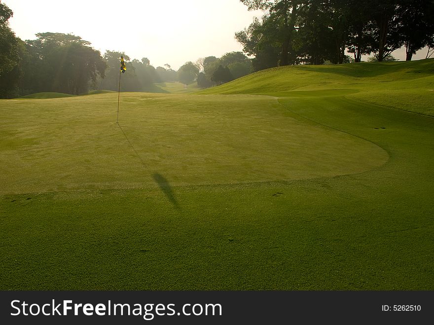 Fairway and green seen in the early morning light. Fairway and green seen in the early morning light