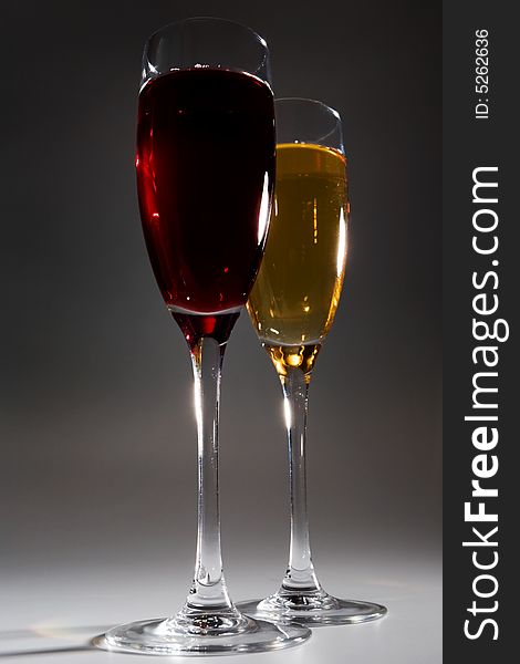 Two glasses with wine on a dark background