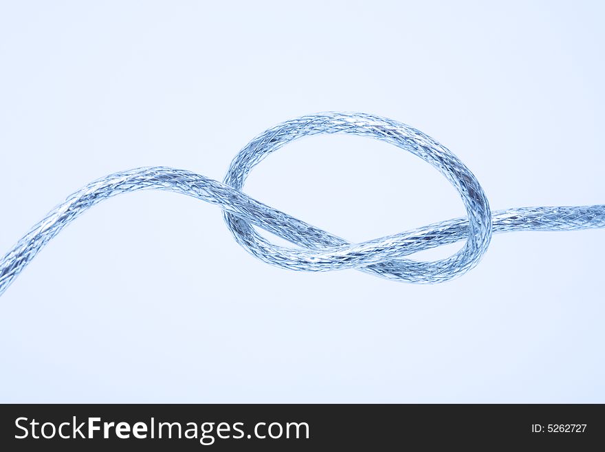 Wire fastened in the knot on a blue background