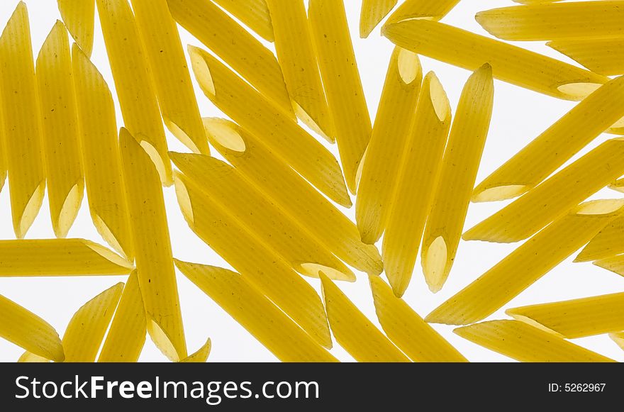 Pieces of penne pasta on a lightbed