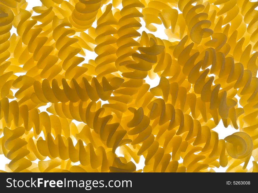 Pieces of fusilli pasta on a lightbed