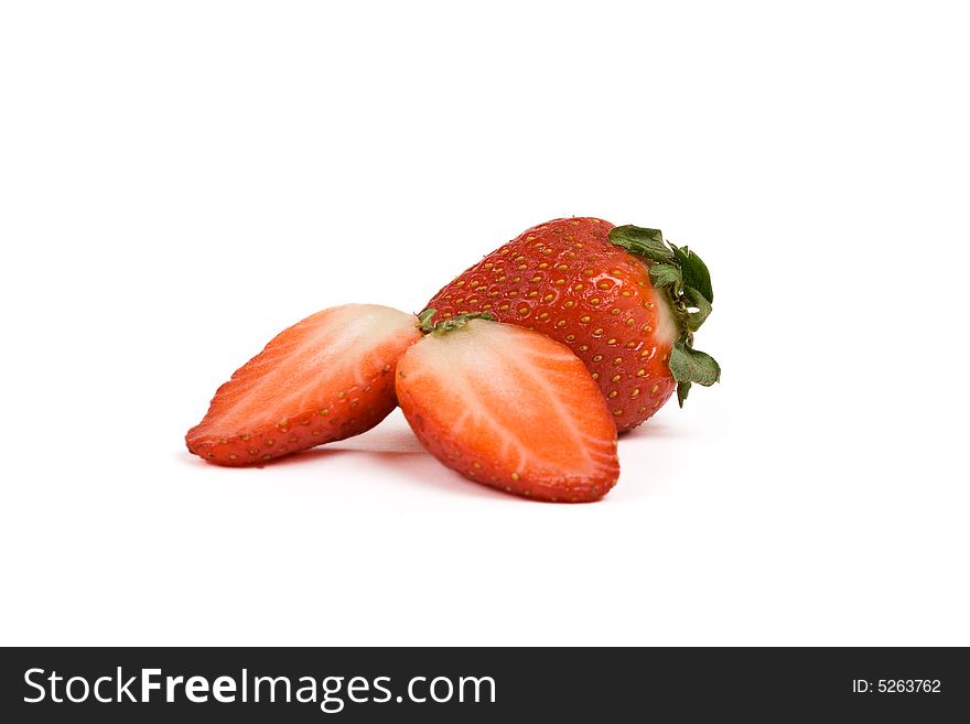 Two strawberries, one cut in half, isolated