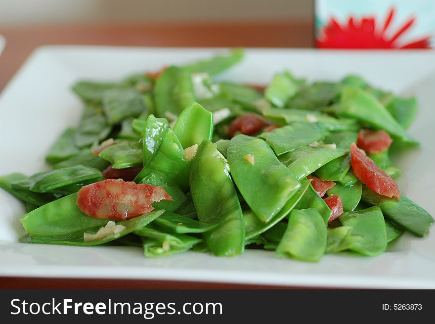 Stir fired snow peas with Chinese sausages. Stir fired snow peas with Chinese sausages.