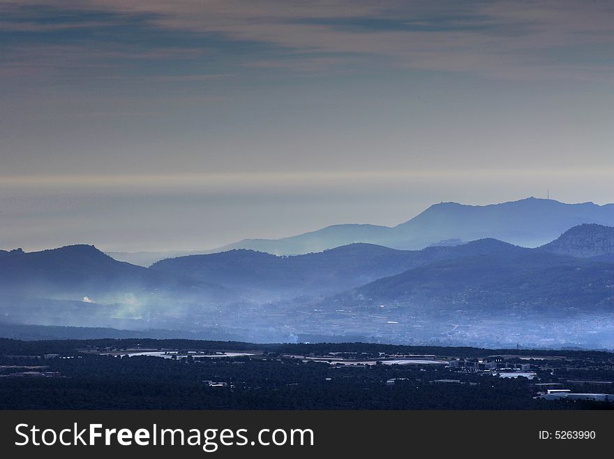 Landscape with mountains fog in a blue tone