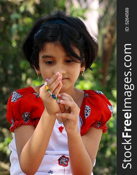 A girl putting the beautiful Indian bracelet in her hand. A girl putting the beautiful Indian bracelet in her hand.