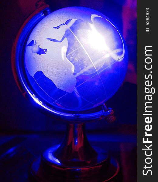 The globe in shining neon blue light. The globe in shining neon blue light