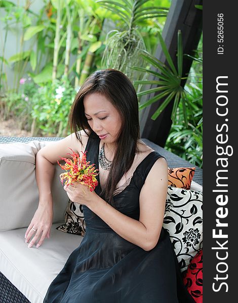 Thai woman holding a bunch of flowers. Thai woman holding a bunch of flowers.