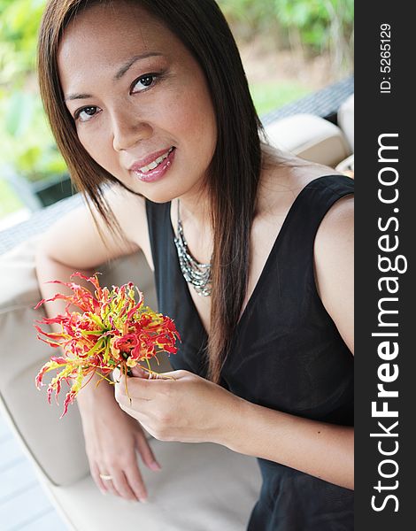 Portrait of an Asian woman holding a bunch of flowers. Portrait of an Asian woman holding a bunch of flowers.