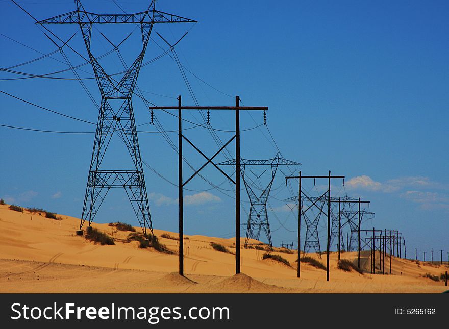 Power lines running across Imperial Dunes in California. Power lines running across Imperial Dunes in California