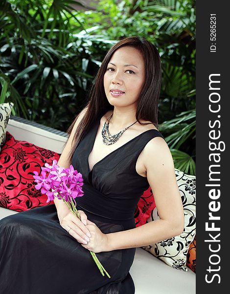Portrait of an Asian woman holding a bunch of flowers. Portrait of an Asian woman holding a bunch of flowers.