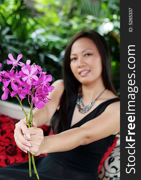 Portrait of an Asian woman holding a bunch of flowers. Portrait of an Asian woman holding a bunch of flowers.