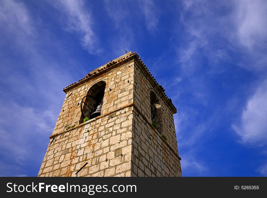 Ancient (probably medieval) tower in a village, with tiny old iron bells. Ancient (probably medieval) tower in a village, with tiny old iron bells.