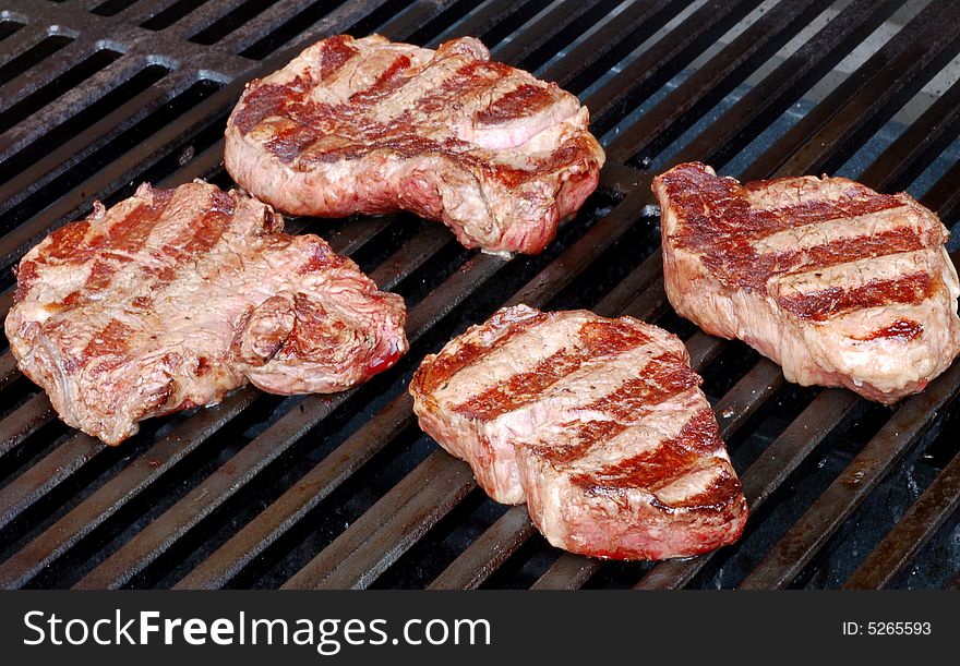 Steaks on the grill at a cookout. Steaks on the grill at a cookout