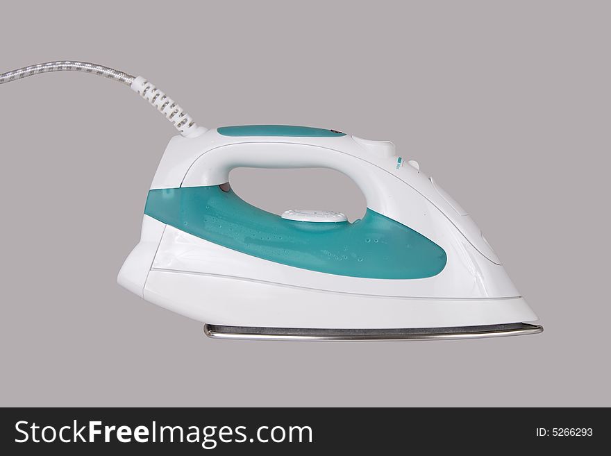 Electric iron on a grey background