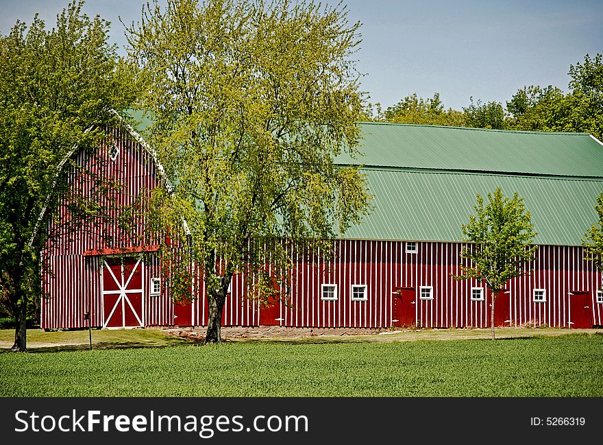 Unique red barn in late spring. Unique red barn in late spring.