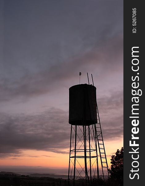 Silhouette of a rural water tank at dawn.  Dansey's Pass, Otago, New Zealand