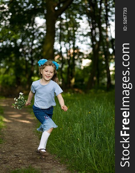 Happy girl running in a summer park