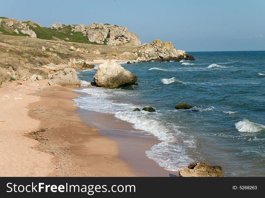 Sand Beach And Rocks Near Of Sea