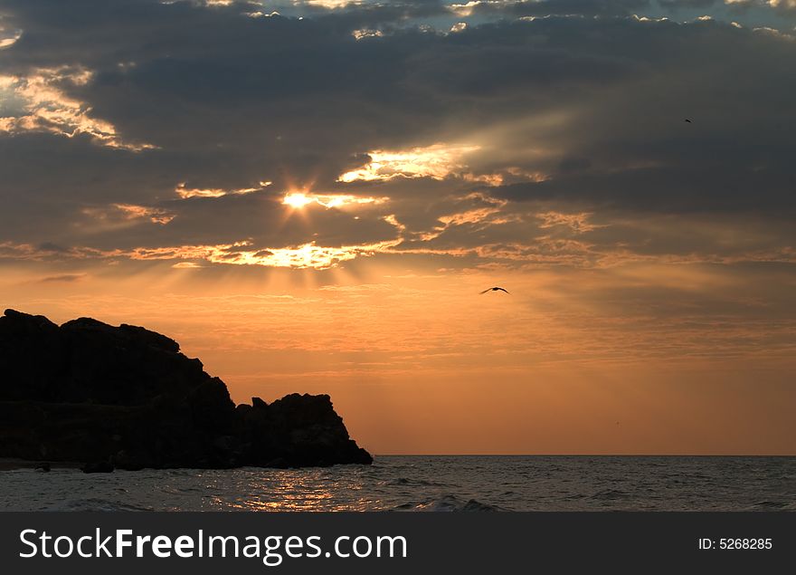 Sunset with sunbeam throw clouds  over sea. Sunset with sunbeam throw clouds  over sea