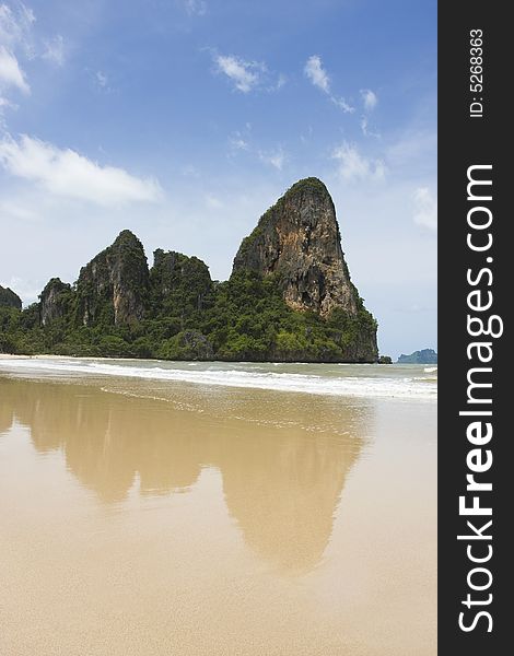 Railay beach, Southern Thailand. Limestone cliff rocks in background