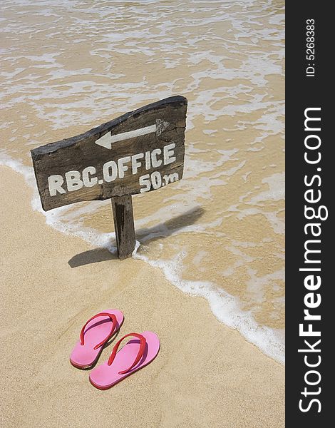 Colorful pink flip flops and wooden sign on the beach. Colorful pink flip flops and wooden sign on the beach