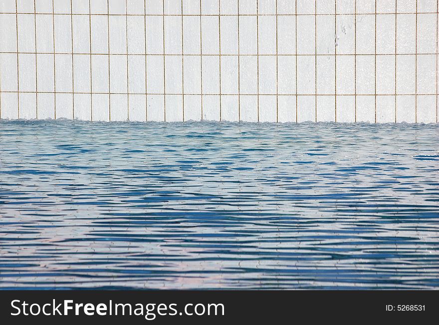 Detail of a white tiled swimming pool