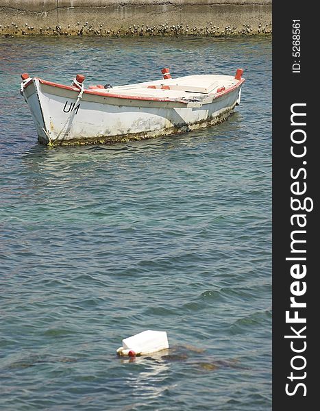 White fishing boat moored in an harbor