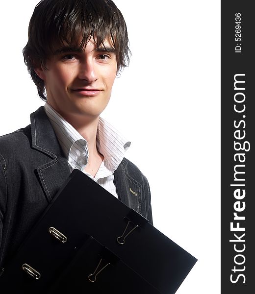 A portrait about an attractive young businessman who is smiling and he is holding some folders. He is wearing a white shirt and a stylish black suit. A portrait about an attractive young businessman who is smiling and he is holding some folders. He is wearing a white shirt and a stylish black suit.