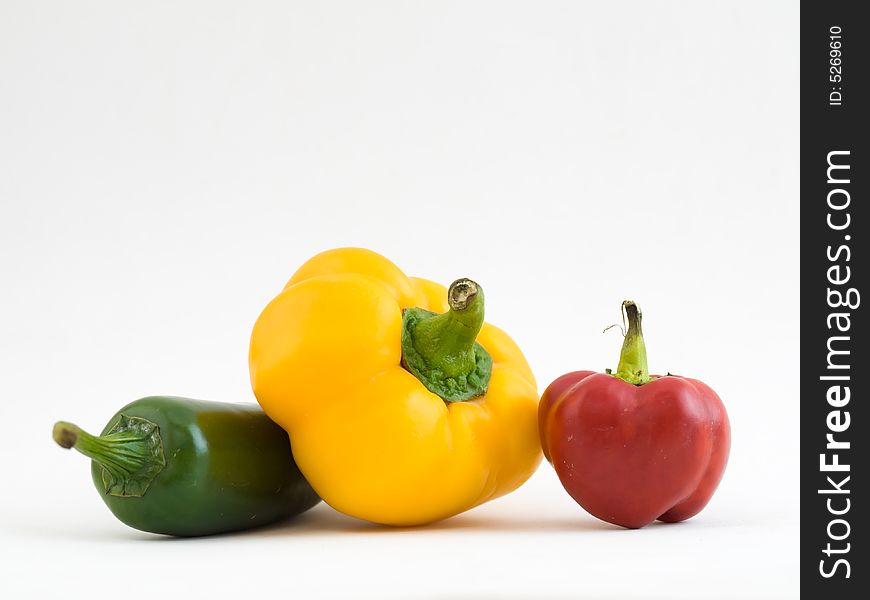 Still life of three differently shaped and colored chillies. Still life of three differently shaped and colored chillies