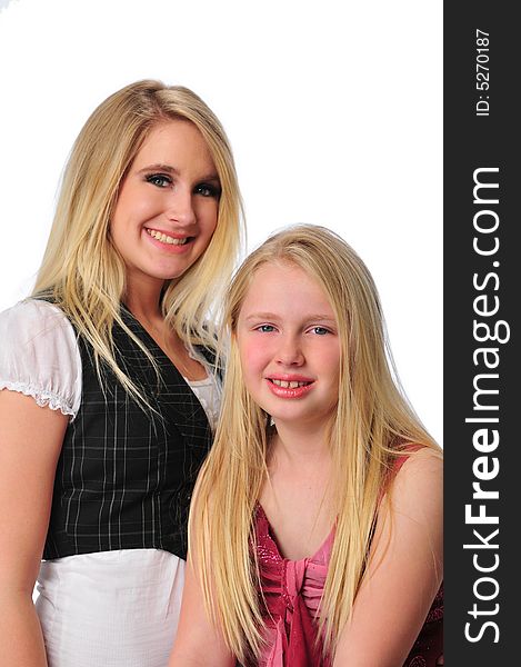 Two sisters smiling isolated on a white background