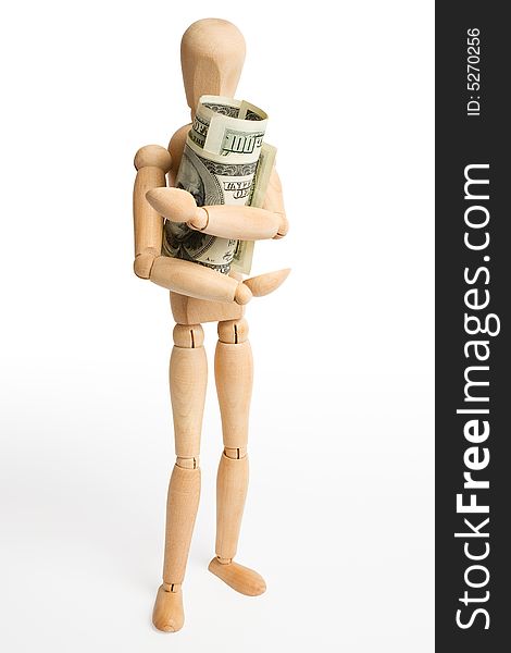 The wooden figure holds dollars.Isolated on white [with clipping path]. The wooden figure holds dollars.Isolated on white [with clipping path].