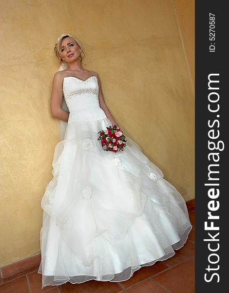 A bride standing against a wall. A bride standing against a wall