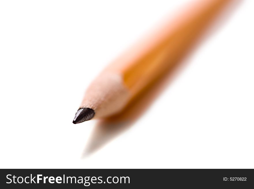 A macro of a yellow school pencil with very, very shallow depth of field on a white background. A macro of a yellow school pencil with very, very shallow depth of field on a white background