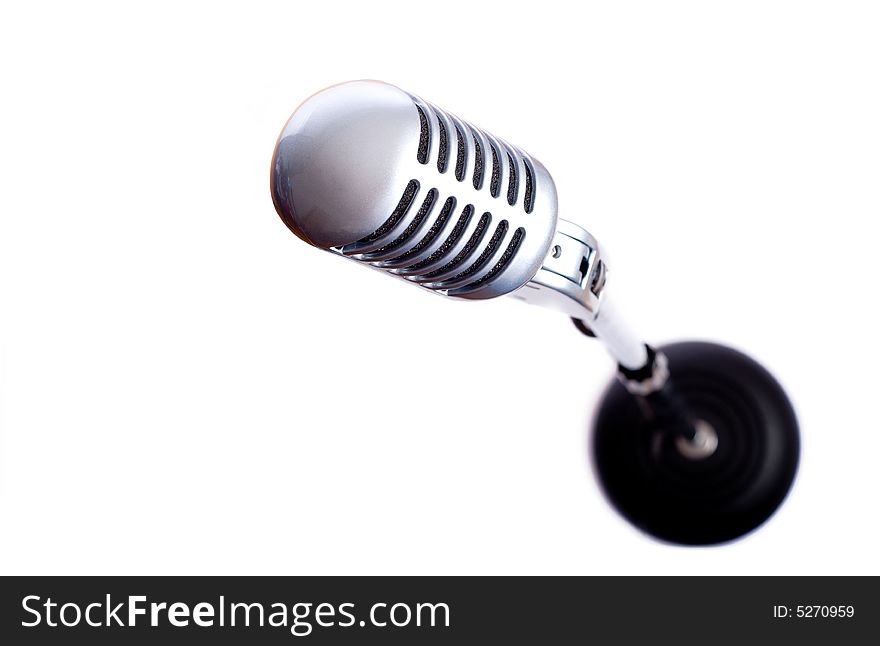A vintage looking microphone on a white background with copy space. A vintage looking microphone on a white background with copy space