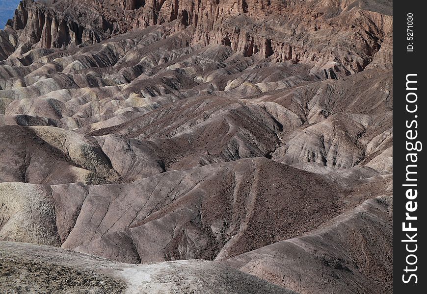 High, unvegetated mountains of sombre reddish colour. 
In Death Valley temperatures can exceed 130Â°F in summer. High, unvegetated mountains of sombre reddish colour. 
In Death Valley temperatures can exceed 130Â°F in summer.