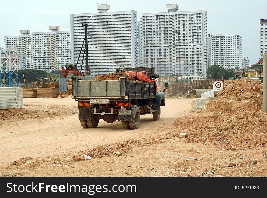 A truck carried soil and rocks at construction site. A truck carried soil and rocks at construction site.