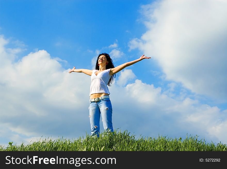 Happy young woman dreams to fly on winds