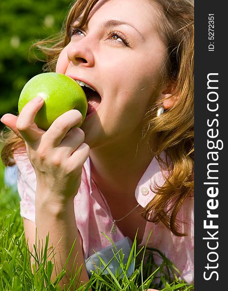 Pretty woman eating green apple