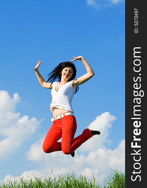 Happy young woman is jumping