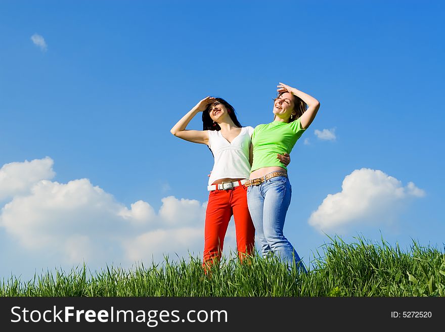 Two young women on a green meadow. Two young women on a green meadow