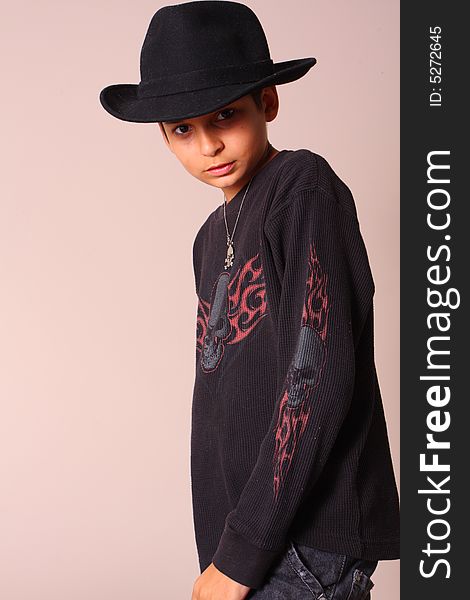 Boy wearing dark clothing and a black hat. Boy wearing dark clothing and a black hat.