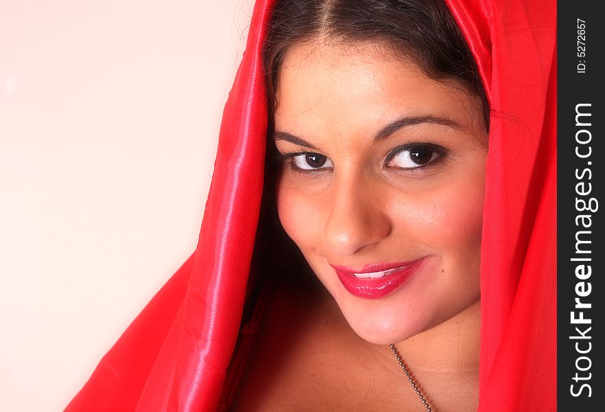 Young woman wearing a red veil. Young woman wearing a red veil