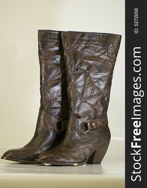 A pair of ladies boots manufactured from synthetic 'leather'.