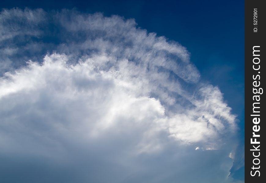 Fissures erupting at the edge of a large cumulus cloud. Fissures erupting at the edge of a large cumulus cloud