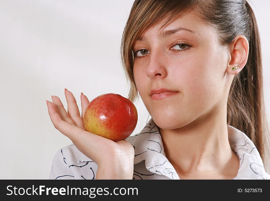 The girl cares about health eats a red apple