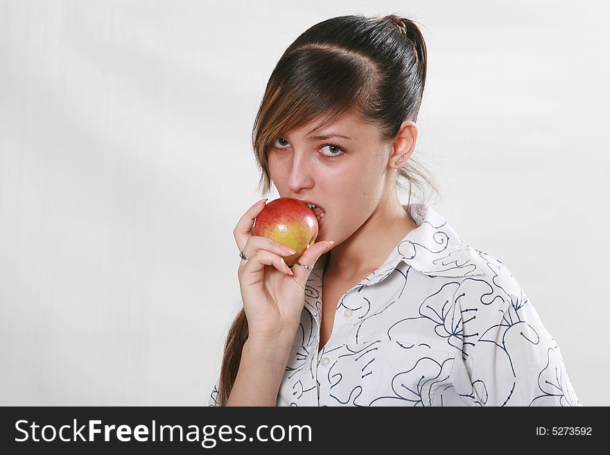 The girl cares about health eats a red apple